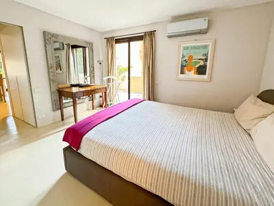 a bedroom with a large bed and a desk at Green Heaven Apt, Rickeys in Cap d'Ail