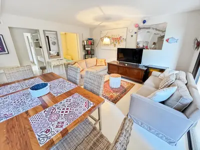 a living room with a table and a couch at Green Heaven Apt, Rickeys in Cap d'Ail