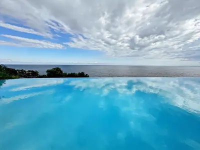 a swimming pool with a view of the ocean at Green Heaven Apt, Rickeys in Cap d'Ail