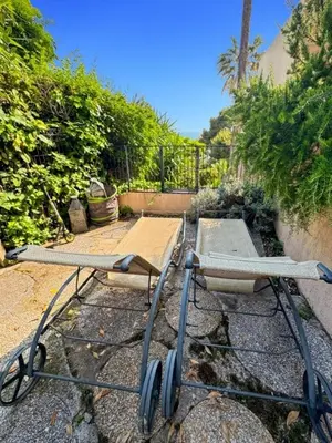 a cart sitting on the ground in a yard at Green Heaven Apt, Rickeys in Cap d'Ail
