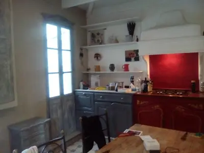 a kitchen with a stove and a table in it at Maison authentique in Nice
