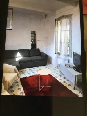 a living room with a couch and a table at Maison authentique in Nice
