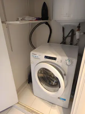 a washer and dryer in a small room at Nice studio 5 minutes walk from the beach in Cagnes-sur-Mer
