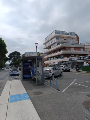 a man is standing at a bus stop at Nice studio 5 minutes walk from the beach in Cagnes-sur-Mer