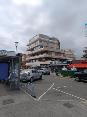 a parking lot with cars parked in front of a building at Nice studio 5 minutes walk from the beach in Cagnes-sur-Mer