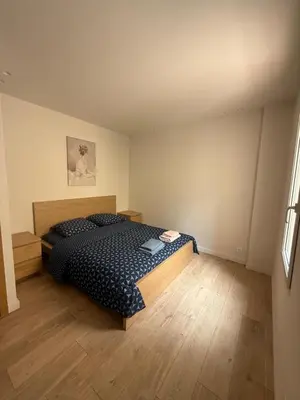 a bedroom with a bed and a wooden floor at Appartement Duplex Bord de Mer in Cagnes-sur-Mer