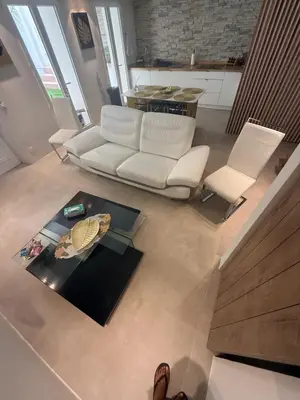 a living room with a white couch and a table at Appartement Duplex Bord de Mer in Cagnes-sur-Mer