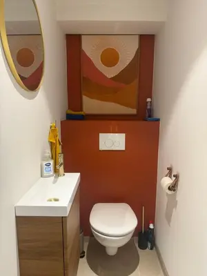 a bathroom with a toilet and a sink and a mirror at Appartement Duplex Bord de Mer in Cagnes-sur-Mer