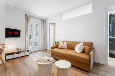 a living room with a couch and a table at Nice Renting - 35 Massena - Architect Flat Ultimate Charm Massena Center in Nice