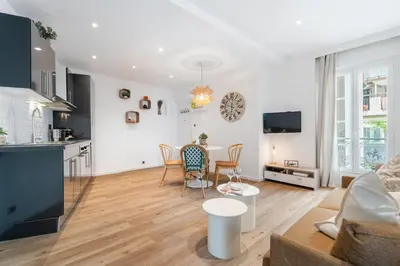 a living room with a kitchen and a table at Nice Renting - 35 Massena - Architect Flat Ultimate Charm Massena Center in Nice