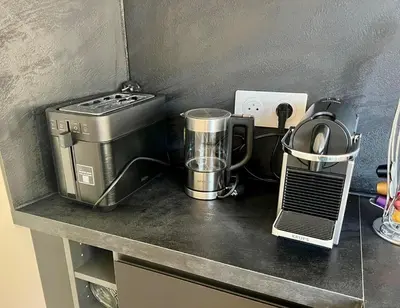 a counter top with a coffee maker and a blender at Appartement Vue Mer T2 Cosy, Plage à pied 3 mins, Coucher de Soleil, Parc privé in Nice