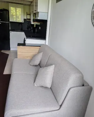 a couch with two pillows sitting in a kitchen at Cosy Mezzanine Studio - Nice Notre Dame - 10 min Promenade in Nice