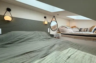 a bedroom with a large bed and two mirrors at Nice studio in the heart of Old Nice - 4 pers in Nice