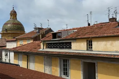 a group of roofs with a mosque in the background at Nice studio in the heart of Old Nice - 4 pers in Nice