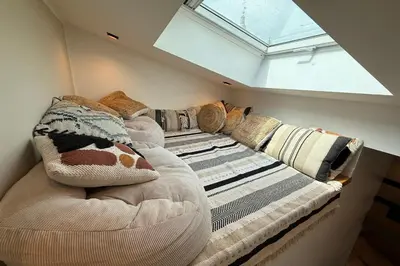 a room with a couch with pillows and a window at Nice studio in the heart of Old Nice - 4 pers in Nice