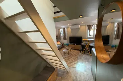 a staircase leading to a living room and a living room at Nice studio in the heart of Old Nice - 4 pers in Nice
