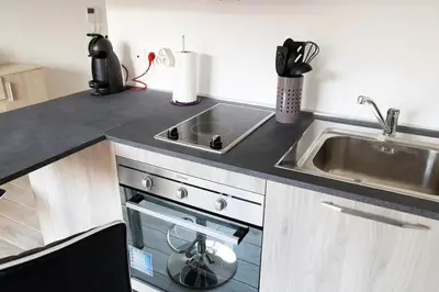 a kitchen counter with a sink and a dishwasher at Studio climatisé au calme, mezzanine et balcon in Nice