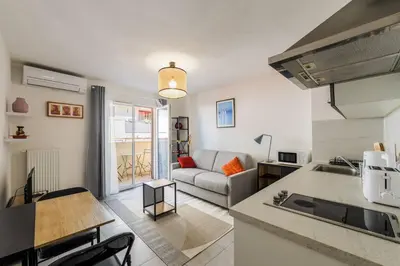 a kitchen and a living room with a couch at Studio au port de nice in Nice