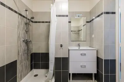 a bathroom with a white sink and a shower at Studio au port de nice in Nice