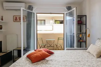 a bedroom with a bed with an orange pillow on it at Studio au port de nice in Nice