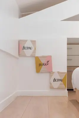 a bedroom with signs on the wall with the words home and sweet at Blue Escape Nice in Nice