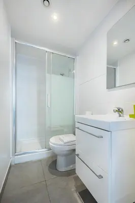 a white bathroom with a toilet and a shower at Blue Escape Nice in Nice