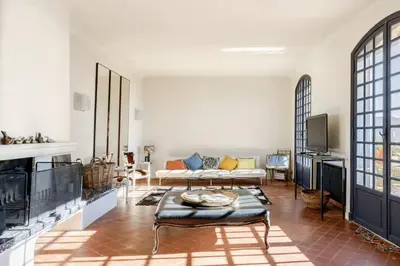 a living room with a couch and a table at Séjour de luxe sur les collines niçoises in Nice