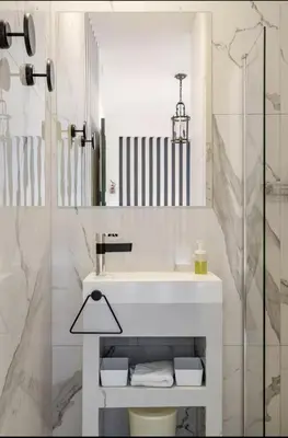 a white bathroom with a sink and a shower at Séjour de luxe sur les collines niçoises in Nice