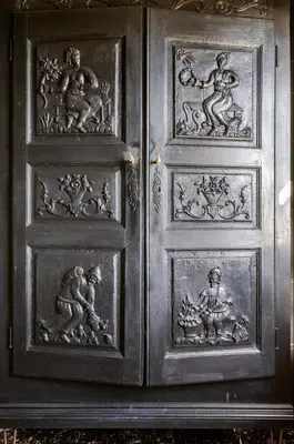 a wooden door with drawings of people on it at Séjour de luxe sur les collines niçoises in Nice