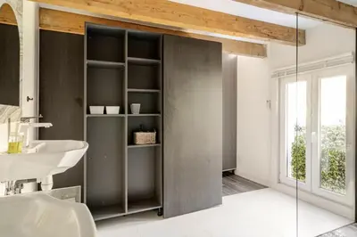 a bathroom with a sink and a glass door at Séjour de luxe sur les collines niçoises in Nice