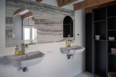 a bathroom with two sinks and a mirror at Séjour de luxe sur les collines niçoises in Nice