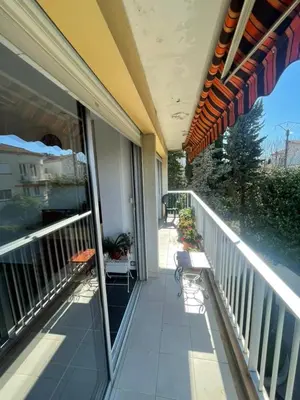 a balcony of a house with a table and chairs at Beautiful 3-room apartment with terrace in Nice
