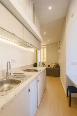 a kitchen with white cabinets and a sink at Studio Masséna - Mer et Vieux Nice pour 4 personnes in Nice