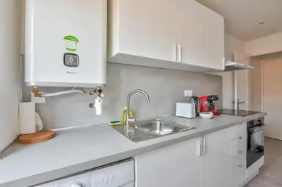 a kitchen with white cabinets and a sink at Magnifique studio en plein centre de Nice in Nice