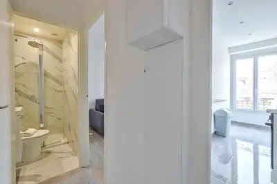 a bathroom with a toilet and a glass door at Magnifique studio en plein centre de Nice in Nice
