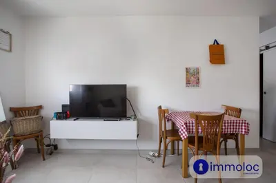 a living room with a couch and a table at Studio near airport in Nice