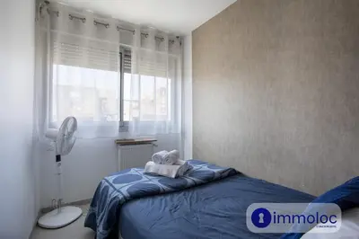 a bedroom with a bed with a towel on it at Studio near airport in Nice