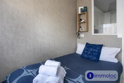 a bedroom with a bed with towels on it at Studio near airport in Nice