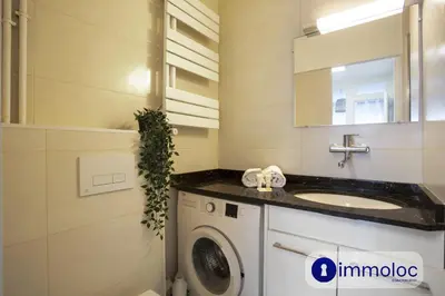 a bathroom with a washing machine and a sink at Studio near airport in Nice