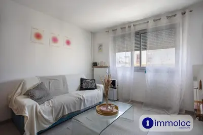 a bedroom with a bed and a desk with a television at Studio near airport in Nice