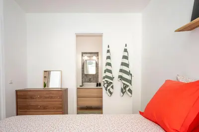 a bedroom with a bed and a dresser and a mirror at Superbe 2 pièces contemporain au cœur de Nice in Nice