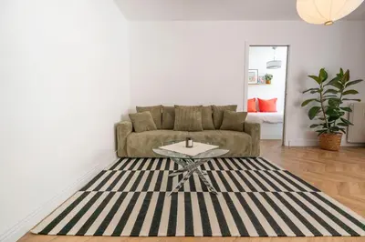 a living room with a couch and a table at Superbe 2 pièces contemporain au cœur de Nice in Nice