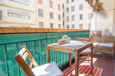 a table and chairs on the balcony of a building at Superbe 2 pièces contemporain au cœur de Nice in Nice