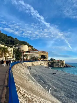 a beach with buildings and people on the beach at Superbe 2 pièces contemporain au cœur de Nice in Nice