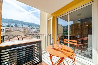 a balcony with a table and a view of the city at Studio port de Nice Clim Balcon in Nice