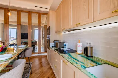 a kitchen with wooden cabinets and a counter top at BAY VIEW AP4470 By Riviera Holiday Homes in Villefranche-sur-Mer