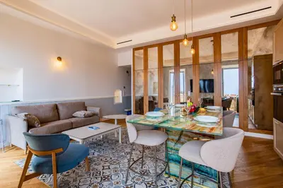 a living room with a table and chairs and a couch at BAY VIEW AP4470 By Riviera Holiday Homes in Villefranche-sur-Mer