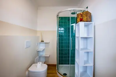 a bathroom with a toilet and a glass shower at Dina palace AP4462 By Riviera Holiday Homes in Villefranche-sur-Mer