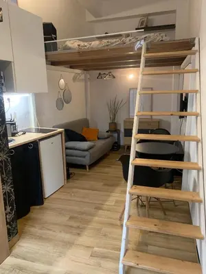 a room with a loft bed and a kitchen at Studette Cosy in Nice