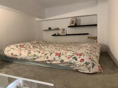 a bed with a floral comforter in a bedroom at Studette Cosy in Nice